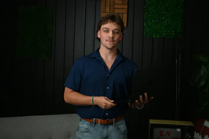 Aiden Edwards with a laptop in the JamFam studio